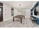 A spacious game room featuring a billiards table, stylish lighting, and cozy seating for entertainment at 5810 Fieldmoor Ct, Palmetto, FL 34221