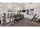 Bright gym featuring dumbbells, a weight bench, a mirror, and ceiling fans at 5810 Fieldmoor Ct, Palmetto, FL 34221