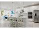 Kitchen features stainless steel appliances, a center island with bar seating, and an open floor plan at 5810 Fieldmoor Ct, Palmetto, FL 34221