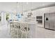 Bright kitchen featuring white cabinets, stainless steel appliances, large island with bar seating, and an adjacent breakfast nook at 5810 Fieldmoor Ct, Palmetto, FL 34221