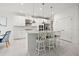 Kitchen with stainless steel appliances, center island with bar seating, custom cabinets, and open floor plan at 5810 Fieldmoor Ct, Palmetto, FL 34221
