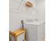 Functional laundry room with a modern washer and dryer, wooden bench, and overhead shelving at 5810 Fieldmoor Ct, Palmetto, FL 34221