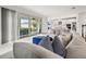 Open concept living room with view of modern kitchen and access to covered outdoor living space at 5810 Fieldmoor Ct, Palmetto, FL 34221