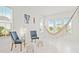 Bright living room with lots of natural light, a hammock, plush decor, and clean tile floors at 5810 Fieldmoor Ct, Palmetto, FL 34221