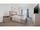 Stylish bedroom with a king bed, neutral color palette, walk-out balcony, and ample natural light at 5810 Fieldmoor Ct, Palmetto, FL 34221
