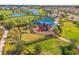 Aerial view of a community playground with slides, a covered play structure and surrounding landscaping at 5810 Fieldmoor Ct, Palmetto, FL 34221