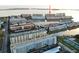 Elevated aerial view of waterfront condos overlooking a serene waterway, featuring lush landscaping and community amenities at 6020 Shore S Blvd # 1008, Gulfport, FL 33707