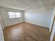 Bedroom with wood-look flooring, neutral walls, and ample natural light from a window at 6020 Shore S Blvd # 1008, Gulfport, FL 33707