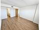 Well-lit bedroom featuring wood-look flooring, neutral walls and convenient access to bathroom at 6020 Shore S Blvd # 1008, Gulfport, FL 33707