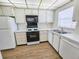 Bright, white galley kitchen includes modern appliances and countertops, maximizing space and functionality at 6020 Shore S Blvd # 1008, Gulfport, FL 33707