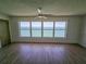 Spacious living room showcasing a large window with stunning water views and a ceiling fan at 6020 Shore S Blvd # 1008, Gulfport, FL 33707
