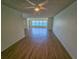 Airy living room with wood laminate flooring, modern ceiling fan, and scenic window views of the water at 6020 Shore S Blvd # 1008, Gulfport, FL 33707