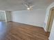 Spacious living room with wood laminate flooring, ceiling fan and blank canvas walls at 6020 Shore S Blvd # 1008, Gulfport, FL 33707