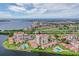 Stunning aerial view of waterfront condo community with pools, golf course, and views of the ocean at 6322 Palma Del Mar S Blvd # 1107, St Petersburg, FL 33715