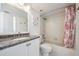 Bathroom with a granite countertop vanity, neutral tile and shower with patterned curtain at 6322 Palma Del Mar S Blvd # 1107, St Petersburg, FL 33715