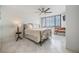 Bright bedroom featuring a queen-sized bed, ceiling fan, and large window with city views at 6322 Palma Del Mar S Blvd # 1107, St Petersburg, FL 33715