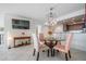Dining area with a glass table, decorative lighting, and open concept access to kitchen at 6322 Palma Del Mar S Blvd # 1107, St Petersburg, FL 33715