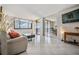 Living room with large windows, sliding glass door, stylish decor, and tile flooring at 6322 Palma Del Mar S Blvd # 1107, St Petersburg, FL 33715