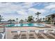 Community pool featuring tiki umbrellas and lounge chairs overlooking the bay at 6322 Palma Del Mar S Blvd # 1107, St Petersburg, FL 33715
