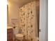 Bathroom with toilet, sink, and shower featuring a decorative shower curtain at 6715 Grand Estuary Trl # 203, Bradenton, FL 34212