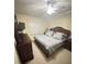 Comfortable bedroom with a ceiling fan, a large dresser, and a serene atmosphere at 6715 Grand Estuary Trl # 203, Bradenton, FL 34212