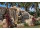 Community entrance with a waterfall feature surrounded by lush tropical landscaping at 6715 Grand Estuary Trl # 203, Bradenton, FL 34212