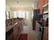 Bright kitchen with granite countertops, stainless steel appliances, and tile flooring at 6715 Grand Estuary Trl # 203, Bradenton, FL 34212