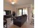 Bright living room with access to the patio, neutral decor, and contemporary furnishings at 6715 Grand Estuary Trl # 203, Bradenton, FL 34212