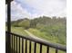Scenic view from the screened patio overlooking a lush, green landscape and walking path at 6715 Grand Estuary Trl # 203, Bradenton, FL 34212