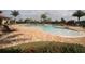 Community pool area with sun loungers and a spacious deck for relaxation at 6715 Grand Estuary Trl # 203, Bradenton, FL 34212