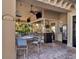 Outdoor tiki bar with an island motif, featuring seating, TVs, and a lush outdoor view at 6715 Grand Estuary Trl # 203, Bradenton, FL 34212
