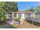 Backyard featuring a trampoline, grill, and plant life, perfect for outdoor enjoyment at 7330 Fairwood Ave, New Port Richey, FL 34653