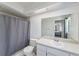 Bathroom featuring a shower with gray curtain, a toilet, and vanity with sink at 7330 Fairwood Ave, New Port Richey, FL 34653