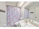 Bright bathroom with decorative unicorn shower curtain and vanity with sink at 7330 Fairwood Ave, New Port Richey, FL 34653