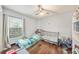 Charming bedroom features laminate wood floors and a ceiling fan at 7330 Fairwood Ave, New Port Richey, FL 34653