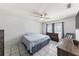 Bedroom with ceiling fan, tile flooring, and a window offering natural light at 7330 Fairwood Ave, New Port Richey, FL 34653