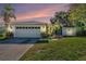 Charming single-story home with a well-manicured lawn and attached two-car garage at 7330 Fairwood Ave, New Port Richey, FL 34653