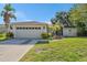 Charming single-story home featuring a well-maintained lawn and attached two-car garage at 7330 Fairwood Ave, New Port Richey, FL 34653