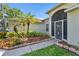Inviting home exterior featuring tropical landscaping and a charming screened entryway at 7330 Fairwood Ave, New Port Richey, FL 34653