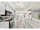 Clean, all-white kitchen with modern appliances and natural light at 7330 Fairwood Ave, New Port Richey, FL 34653