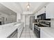 Bright kitchen features tile floors, stainless steel appliances, and ample white cabinets and countertops at 7330 Fairwood Ave, New Port Richey, FL 34653