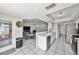 Open kitchen layout with modern appliances and view of the living room at 7330 Fairwood Ave, New Port Richey, FL 34653
