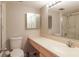 Well-lit bathroom showcasing a vanity with ample counter space and a shower with glass doors at 7400 Sun Island S Dr # 501, South Pasadena, FL 33707