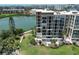 View of the exterior of the building overlooking a tranquil lake and manicured green space at 7400 Sun Island S Dr # 501, South Pasadena, FL 33707