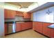 Spacious kitchen with stainless steel dishwasher, tile flooring, and wooden cabinets at 7400 Sun Island S Dr # 501, South Pasadena, FL 33707