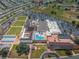 Aerial view of the community featuring a pool, parking, green space, and residential housing at 801 Oakmont Ave, Sun City Center, FL 33573