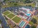 An aerial view showcases the community center, lawn bowling, and the expansive community grounds at 801 Oakmont Ave, Sun City Center, FL 33573