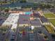 Aerial view showcases a vibrant community with a pool, well-maintained grounds and ample parking at 801 Oakmont Ave, Sun City Center, FL 33573