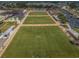 An aerial view showcases the community's premier lawn bowling facilities and surrounding landscape at 801 Oakmont Ave, Sun City Center, FL 33573
