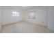 Bedroom with two windows providing ample natural light and neutral walls at 801 Oakmont Ave, Sun City Center, FL 33573
